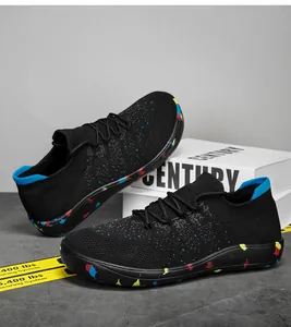 Detailed shot of professional lightweight black knit sneakers with colorful graffiti sole