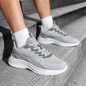 Close-up detail of men's grey breathable fly-knit mesh running shoes on stairs