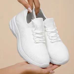Lightweight and breathable white knitted women's sneakers featuring comfortable thick soles