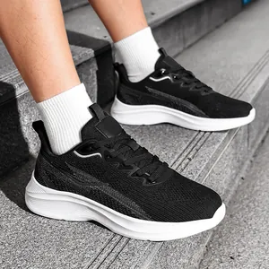 Side view of men's black breathable flyknit running shoes worn on concrete stairs