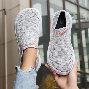 Detail of lightweight breathable grey knit slip-on sneakers with a wide toe box design