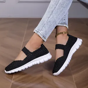 Detailed shot showing the black woven elastic strap of women's white sole flats