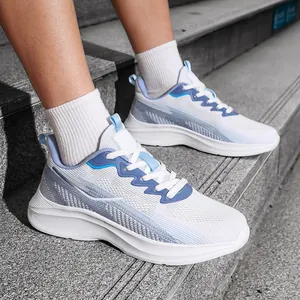Close-up detail of breathable white flyknit running shoes with blue accents worn on feet