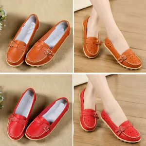 Detail view of orange and wine red leather loafers with perforated texture and solid finish.
