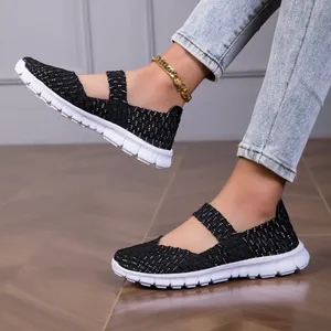 Close-up detail view of women's black woven Mary Jane flat shoes with white speckled pattern