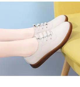Side detail view of women's comfortable soft-sole white leather casual shoes on model