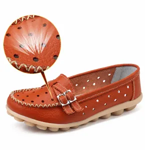 Macro view of genuine leather texture and hollow out detail on brown flat loafers