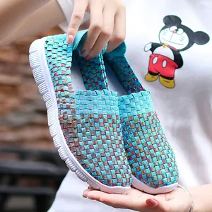 Detailed view of breathable aqua woven stretch slip-on sneakers with a multi-color pattern.