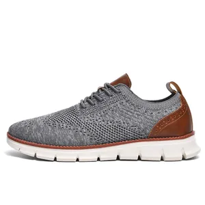 Side view of breathable grey fly-knit men's loafer with brown leather heel accents