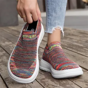Detailed shot of vibrant rainbow fly-knit loafers with thick white breathable sole.