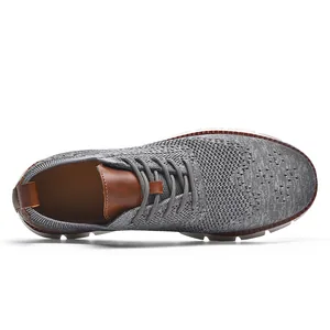 Top-down view of grey breathable knit men's loafer with premium brown leather details