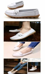 Close-up detail of women's white leather loafers with textured upper and non-slip sole