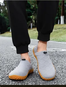 Close-up of grey breathable knit slip-on barefoot shoes for men in outdoor setting