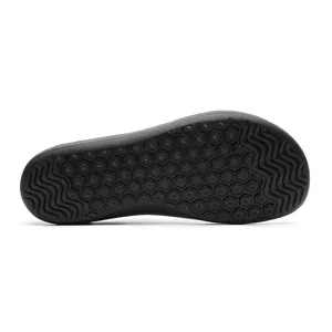 Macro view showing the durable black anti-slip rubber sole of barefoot sneakers