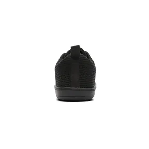 Rear heel detail view of breathable black knit barefoot sneakers with a wide toe box