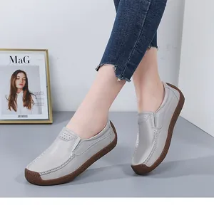 Close-up of stylish grey leather loafers for women with textured non-slip sole.