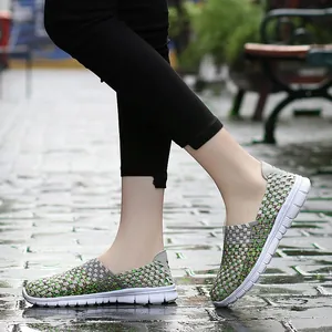 Close-up view of breathable green and grey woven slip-on casual sneakers for women.