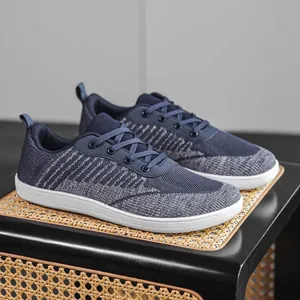 Macro view of navy blue breathable knitted fabric on wide-toe box barefoot sneakers.