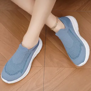 Detail of blue knit sock sneakers with flexible sole and slip-on design.