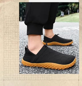 Close-up of lightweight black fly-knit slip-on shoes with textured gum sole