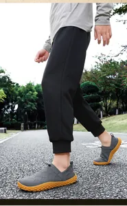Side view of grey fly-knit wide toe slip-on sneakers for outdoor hiking and casual walking