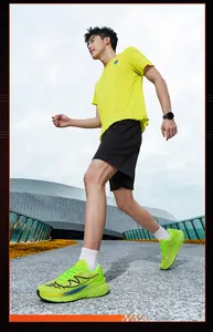Men's neon green wide toe mesh running shoes shown in an outdoor running action shot
