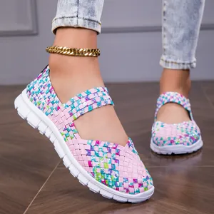 Close-up of pink woven elastic flat sandals featuring vibrant colorful accent patterns