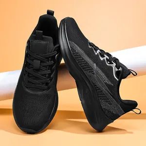 Close-up detail of black breathable mesh men's athletic running sneakers with thick soles