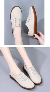 Close-up of beige leather loafers with flexible brown rubber soles for daily wear.