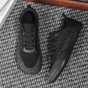 Top-down view of black fly knit barefoot sneakers featuring breathable wide-toe design