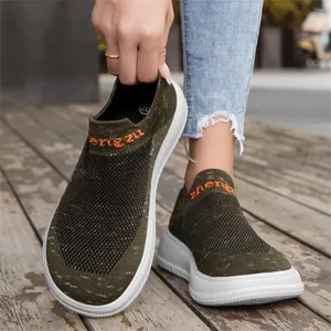 Detail shot of lightweight olive green fly-woven slip-on sneaker with thick white sole.