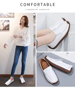 Close-up detail of white leather loafers with breathable perforated upper and brown sole