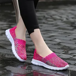 Breathable pink elastic woven casual slip-on sneakers for women on wet pavement