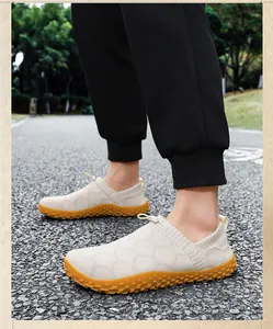 Detail of breathable beige knitted slip-on barefoot shoes with gum rubber sole.