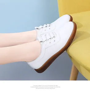 Side view of white soft sole casual loafers for women with textured brown gum sole