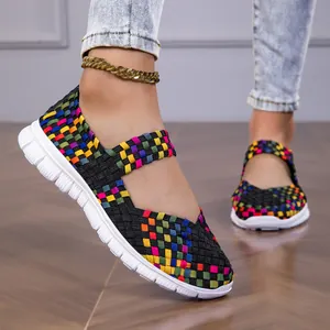 Detail of colorful woven elastic band flats for women with white lightweight sole.