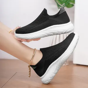 Close-up of black breathable knit slip-on sock sneakers with flexible white soles