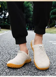 Detail view of breathable fly-knit slip-on men's shoes in an outdoor casual walking scene