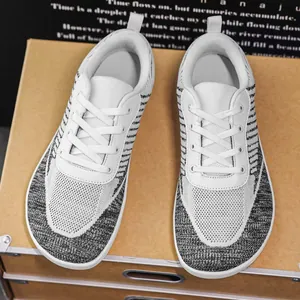 Top view detail of wide toe barefoot sneakers featuring breathable white and grey knit