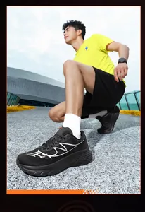 Detail view of men's wide-toe mesh running shoes in black on an outdoor track
