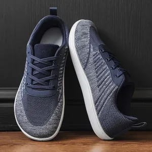 Close-up of navy blue fly-knit barefoot shoes with a breathable wide toe box design.
