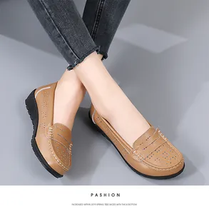 Detailed view of women's hollow tan leather loafers featuring thick soles and white stitching.
