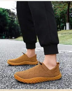 Detailed view of breathable mustard yellow fly-knit barefoot shoes for men outdoors