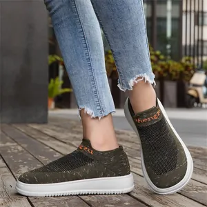 Detailed view of green breathable knitted slip-on sneakers with wide toe
