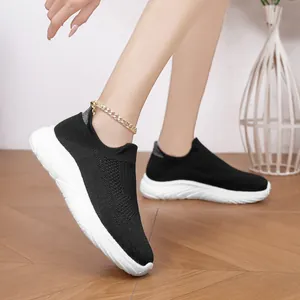 Detailed view of lightweight black breathable knit sock sneakers with flexible white soles