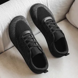 Detail of black breathable knit barefoot shoes with a comfortable wide toe box design.