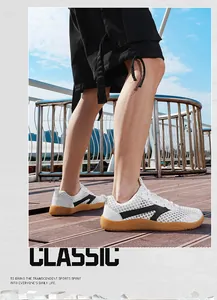 Close-up outdoor view of men's breathable white mesh sneakers with stylish gum soles