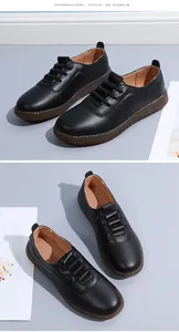 Close-up detail of stylish black leather women's loafers with soft brown anti-slip soles