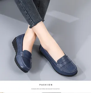 Detailed view of women's blue hollow-out loafers featuring stylish white contrast stitching.