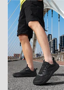 Detailed side view of breathable black mesh outdoor sports sneakers for men